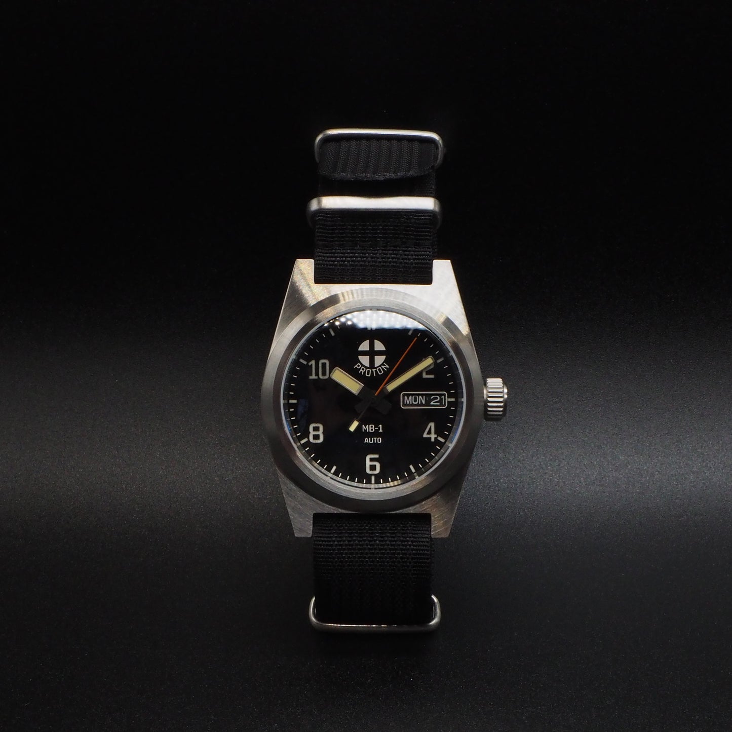 Wristwatch with black strap and metallic case on a dark background