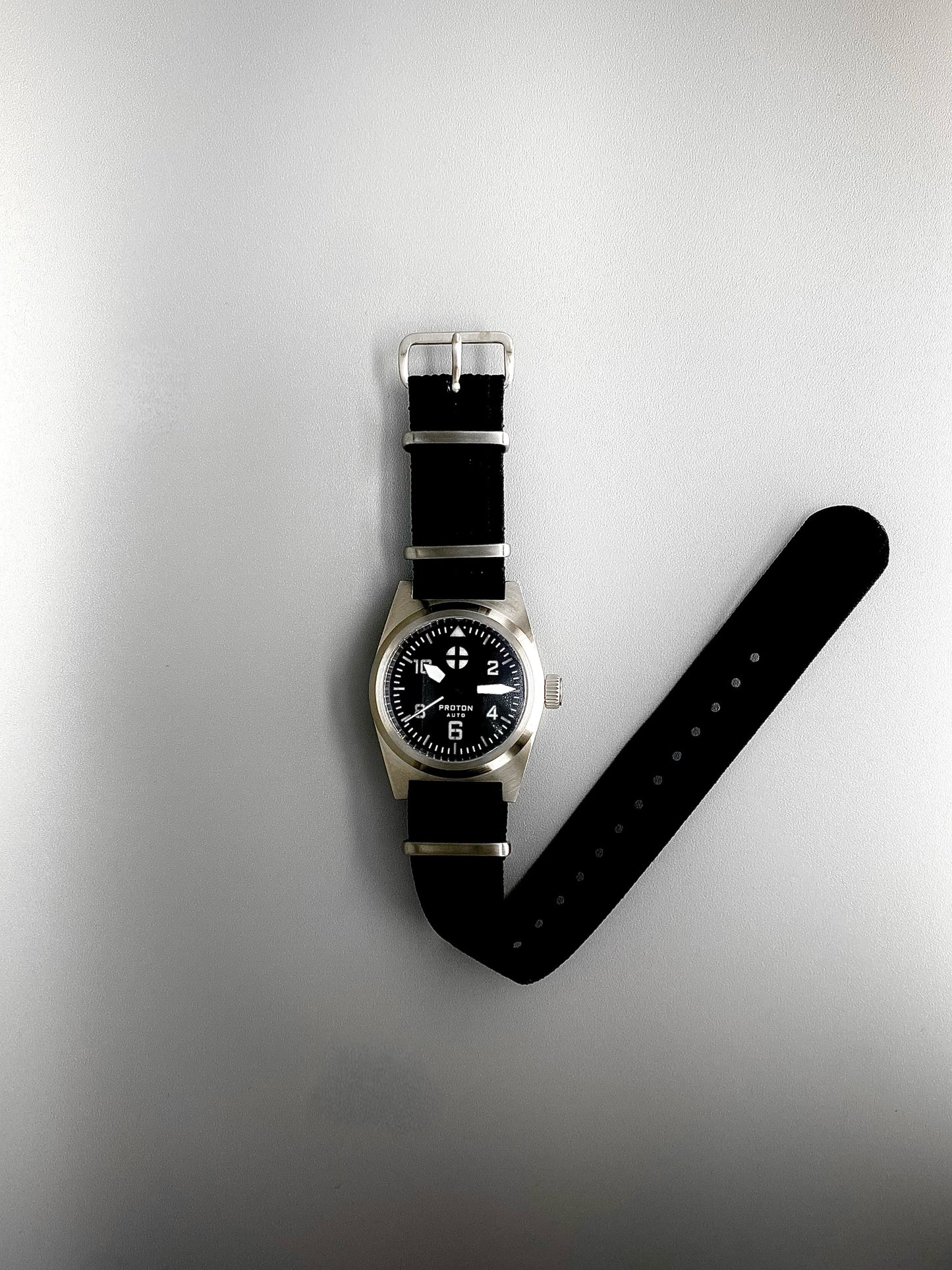 Automatic mechanical watch with white hands on black nylon strap